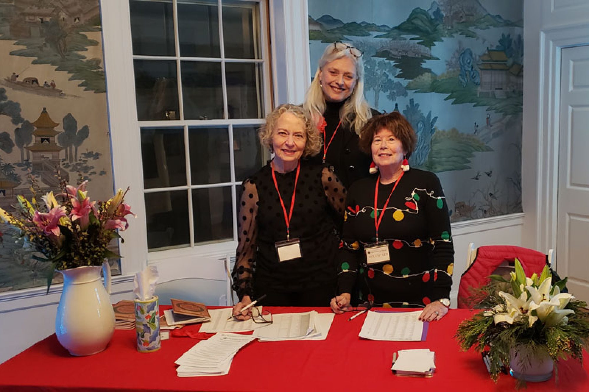 Three women at a check in table